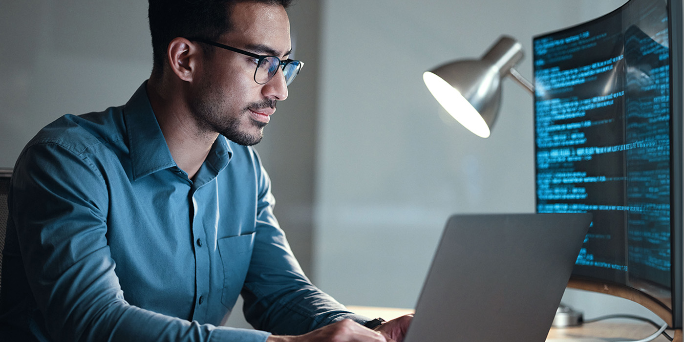 Man with laptop, computer and a lamp